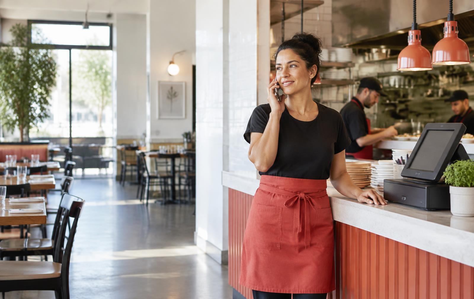 Restaurant manager beside the point-of-sale counter